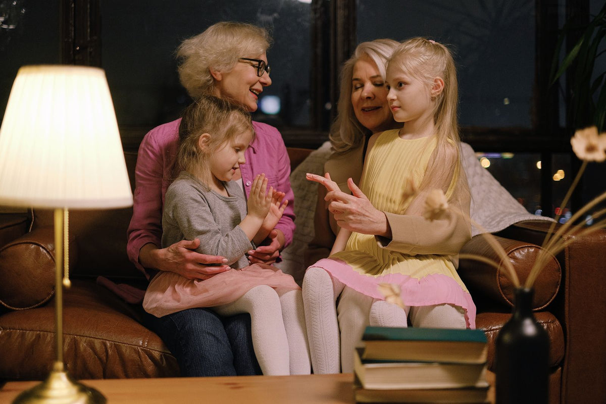 Three generations of a family sitting together on the sofa sharing stories