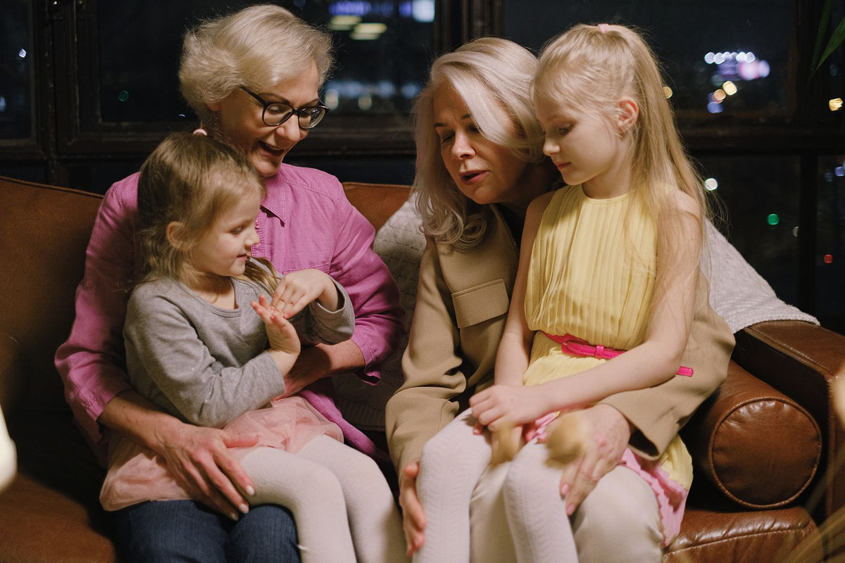 Grandmothers and granddaughters sitting together sharing memories